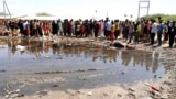 People gather at the site of a blast, after an improvised explosive device (IED) exploded in Elwak Town within Mandera County, April 29, 2024. 
