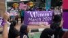 Aktivis membentangkan spanduk saat aksi unjuk rasa Hari Perempuan Internasional di Jakarta, Indonesia, Jumat, 8 Maret 2024. (AP/Dita Alangkara)