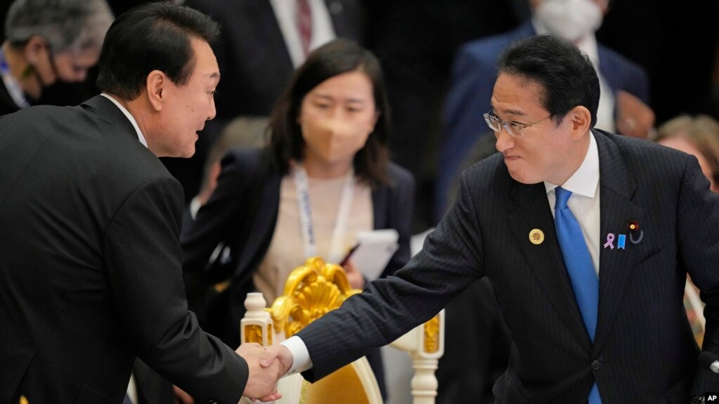 FILE - Japan's Prime Minister Fumio Kishida, right, shakes hands with South Korea's President Yoon Suk Yeol during the ASEAN-East Asia Summit in Phnom Penh, Cambodia, on Nov. 13, 2022. A Japan-ASEAN summit begins Saturday in Tokyo.