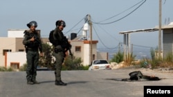 Members of the Israeli forces stand guard during clashes with Palestinians, near Tulkarm, in the Israeli-occupied West Bank, Oct. 5, 2023.