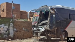 This picture shows a destroyed bus in southern Khartoum, Sudan, on April 19, 2023, amid fighting between Sudan's regular army and paramilitaries following the collapse of a 24-hour truce.