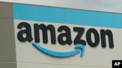 FILE - The familiar sign at the Amazon Robotic Sorting Fulfillment Center in Madison County, Miss., Thursday, Aug. 11, 2022. AP Photo/Rogelio V. Solis)