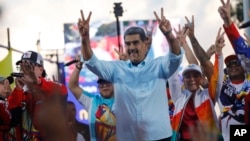 (FILE) Venezuelan President Nicolas Maduro flashes victory hand signs at supporters during a pro-government rally, in Caracas, Venezuela, Aug. 17, 2024. 