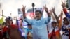 FILE - Venezuelan President Nicolas Maduro flashes victory hand signs at supporters during a pro-government rally, in Caracas, Venezuela, Aug. 17, 2024. 