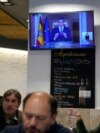 Customers have breakfast in a restaurant while Spanish Prime Minister Pedro Sanchez appears on a television broadcast in Madrid, April 29, 2024. 