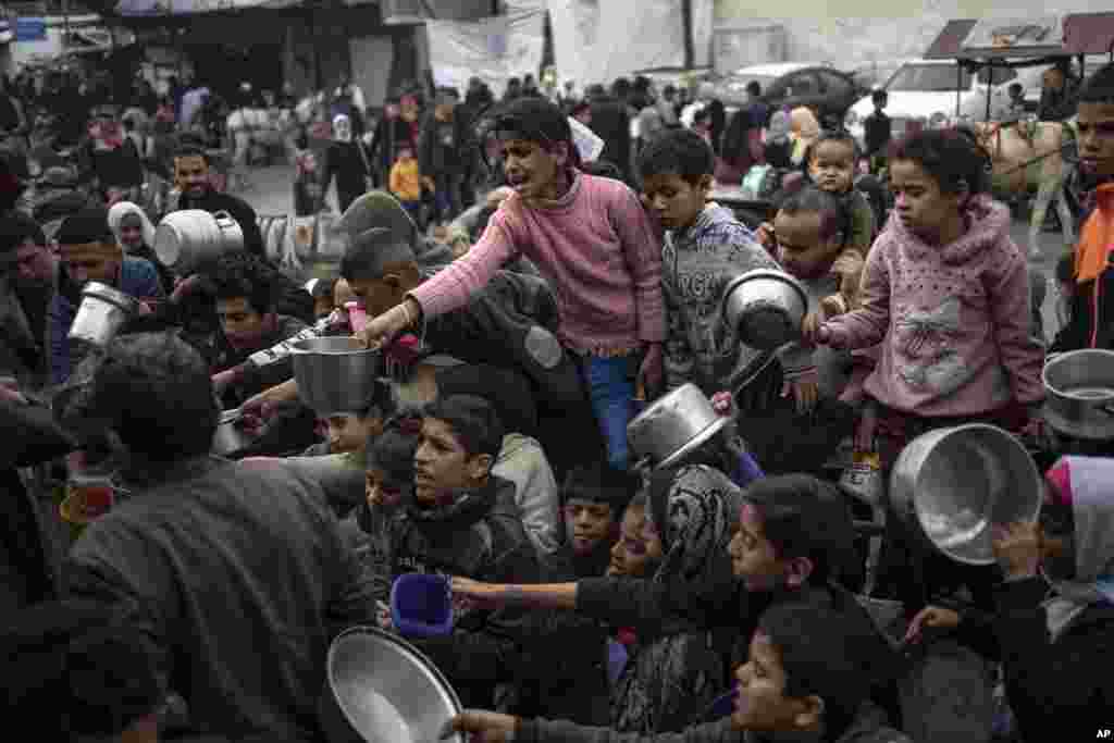 Palestinians line up for a free meal in Rafah, Gaza Strip, Dec. 21, 2023.&nbsp;International aid agencies say Gaza is suffering from shortages of food, medicine and other basic supplies as a result of the two and a half month war between Israel and Hamas.