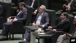 Iranian Industries Minister Reza Fatemi Amin, center, listens during a session of parliament debating his impeachment, in Tehran, Iran, April 30, 2023.