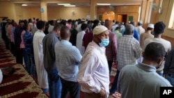 FILE - Muslim men are seen during Friday prayers at the Dar Al-Hijrah mosque in Minneapolis, Minnesota, May 13, 2022. Police said on April 30, 2023, that a man suspected of setting two fires that damaged mosques in the city last week, has been arrested. 