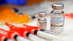 FILE - Pfizer, left, and Moderna bivalent COVID-19 vaccines are readied for use at a clinic, Nov. 17, 2022, in Richmond, Va. 