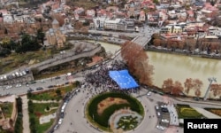 FILE - Participants carry a giant EU flag during a procession in support of Georgia's membership in the European Union, in Tbilisi, Georgia, on Dec. 9, 2023.