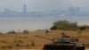 FILE - A retired military tank is seen on the beach with China in the background in Kinmen, Taiwan December 20, 2023.