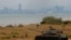 FILE - A retired military tank is seen on the beach with China in the background in Kinmen, Taiwan December 20, 2023.