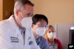 In this photo, Dr. Clifford Robinson works with others during an experimental treatment using radiation on the heart of Jeff Backus in St. Louis on Tuesday, Feb. 14, 2023. (Huy Mach/Washington University, St. Louis via AP)