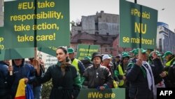 FILE - Romanian farmers protest in front of the European Commission headquarters in Bucharest, Romania, April 7, 2023. Farmers say the influx of cheaper Ukraine grain and other agricultural products is causing prices to drop and saturating demand. 