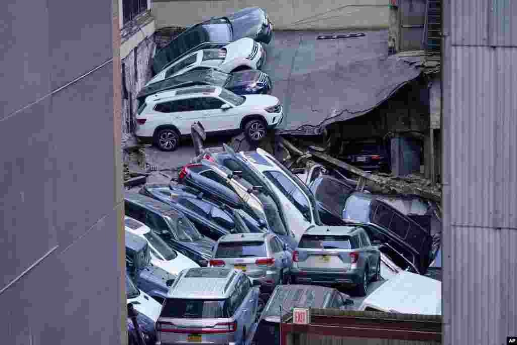 Cars are seen piled on top of each other at the scene of a partial collapse of a parking garage in the Financial District of New York, April 18, 2023.