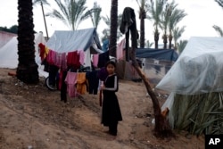 Palestinians displaced by the Israeli bombardment of the Gaza Strip are seen in tents in town of Khan Younis, Dec. 13, 2023.