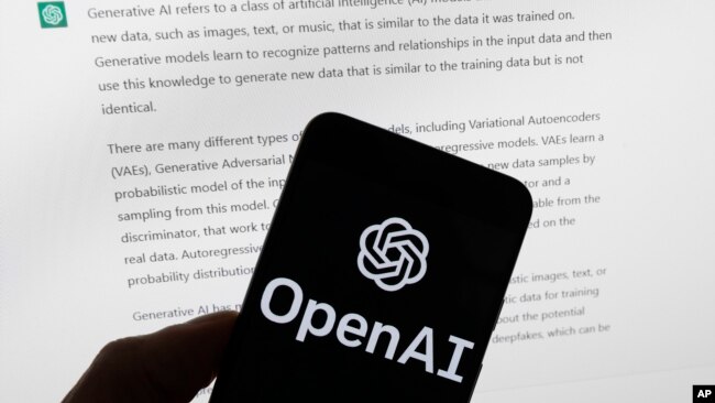 FILE - The OpenAI logo is seen on a mobile phone in front of a computer screen displaying output from ChatGPT, March 21, 2023, in Boston.