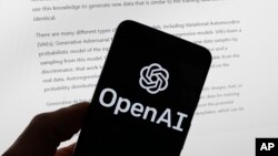 FILE - The OpenAI logo is seen on a mobile phone in front of a computer screen displaying output from ChatGPT, March 21, 2023, in Boston. (AP Photo/Michael Dwyer, File)