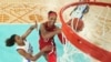 United States' A'ja Wilson shoots for a basket as Marieme Badiane, attempts to block, during a women's gold medal basketball game between the United States and France at Bercy Arena, Aug. 11, 2024, in Paris.