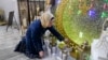 FILE - Suzanne Jaber of The Eid Shop looks at some of her company's Ramadan decorations she created, in Dearborn Heights, Michigan, March 27, 2023. Ramadan starts Sunday or Monday, depending on moon sightings.