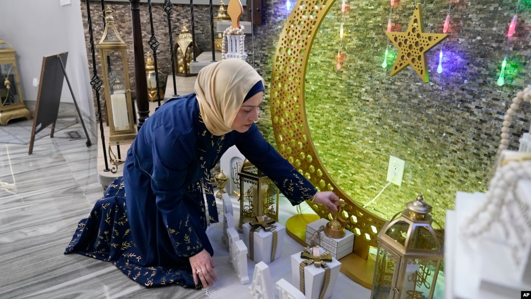 FILE - Suzanne Jaber of The Eid Shop looks at some of her company's Ramadan decorations she created, in Dearborn Heights, Michigan, March 27, 2023. Ramadan starts Sunday or Monday, depending on moon sightings.