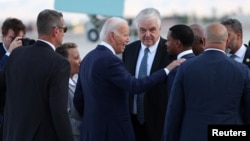 U.S. President Joe Biden is greeted by congressional members outside Air Force One at Harry Reid International Airport in Las Vegas, Nevada, July 15, 2024. 