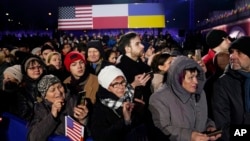 A crowd waits for President Joe Biden to arrive to deliver a speech marking the one-year anniversary of the Russian invasion of Ukraine, Feb. 21, 2023, at the Royal Castle Gardens in Warsaw.