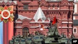 FILE - A Soviet-era E-34 tank leads the column of Russian armored vehicles in Red Square during the Victory Day military parade in Moscow, May 9, 2023, marking the 78th anniversary of the end of World War II.