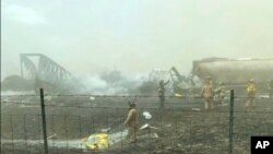 First responders work the scene of a crash involving at least 20 vehicles that shut down a highway in Illinois, Monday, May 1, 2023. 