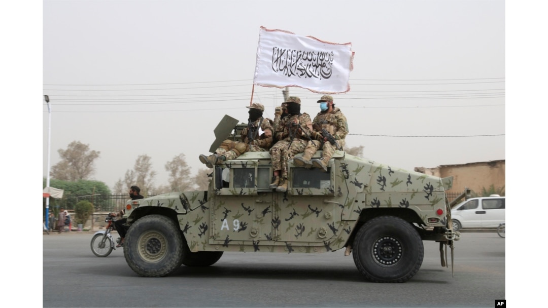 FILE - Taliban fighters patrol on the road during a celebration marking the second anniversary of the withdrawal of U.S.-led troops from Afghanistan, in Kandahar, south of Kabul, Afghanistan, Aug. 15, 2023.