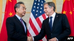 FILE - U.S. Secretary of State Antony Blinken, right, greets China's top diplomat Wang Yi in Bali on July 9, 2022. The two met again Feb. 18, 2023, in Munich, Germany, where Blinken told Wang the violation of U.S. airspace by China’s surveillance balloon must never occur again. 