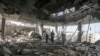 Des Palestiniens se tiennent dans les ruines d'une maison familiale, détruite par une frappe israélienne qui aa ussi tué au moins deux adultes et cinq garçons et filles de moins de 16 ans à Rafah, dans le sud de la bande de Gaza, le vendredi 3 mai 2024. (AP/Ismaël Abou Dayyah)