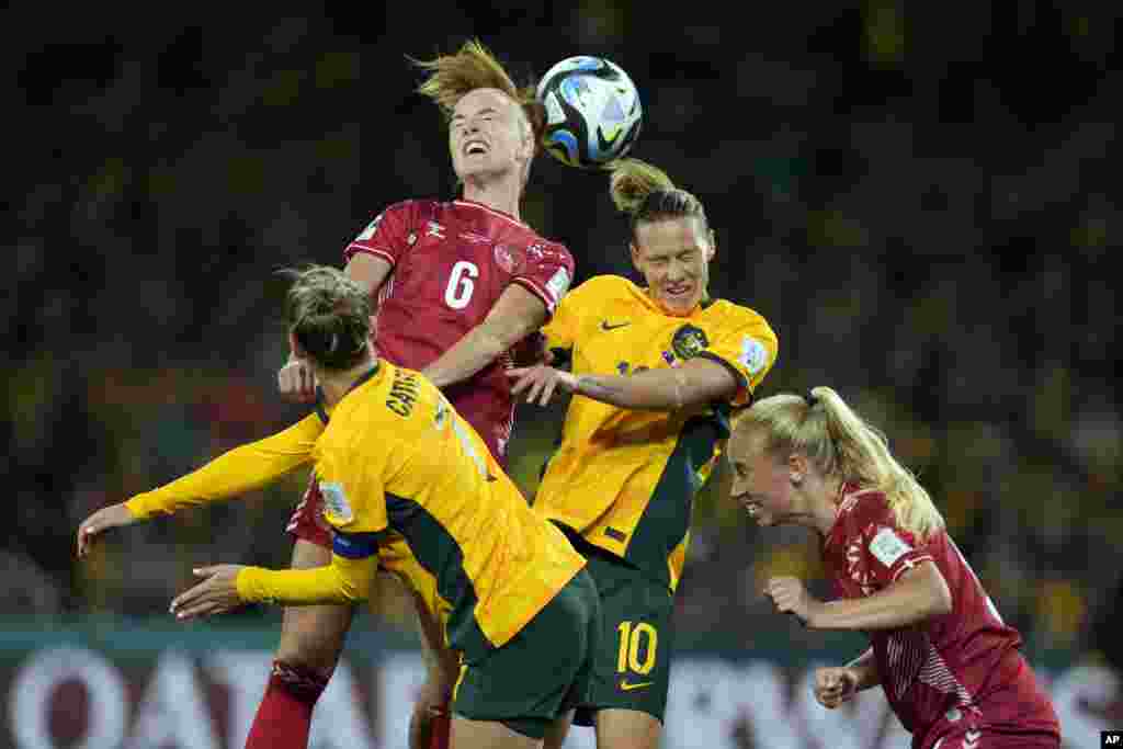 Denmark&#39;s Karen Holmgaard, top left, and Australia&#39;s Emily Van Egmond, top right, jump for the ball during the Women&#39;s World Cup round of 16 soccer match between Australia and Denmark at Stadium Australia in Sydney.