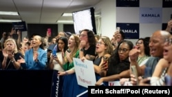 Campaign staff cheer for U.S. Vice President Kamala Harris on her first visit to her Presidential Campaign headquarters in Wilmington, Delaware, July 22, 2024. 