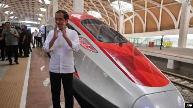 Presiden Joko Widodo memberi isyarat saat uji coba kereta cepat baru Bandung-Jakarta di Jakarta,13 September 2023. (AKBAR NUGROHO GUMAY / POOL / AFP)