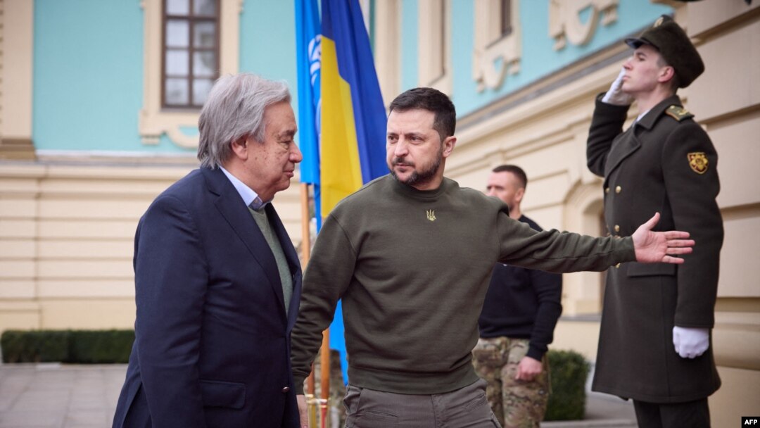 This handout picture taken and released by Ukrainian Presidential press service on March 8, 2023 shows Ukrainian President Volodymyr Zelensky (R) welcoming Secretary-General of the United Nations António Guterres (L) prior to their meeting in Kyiv.