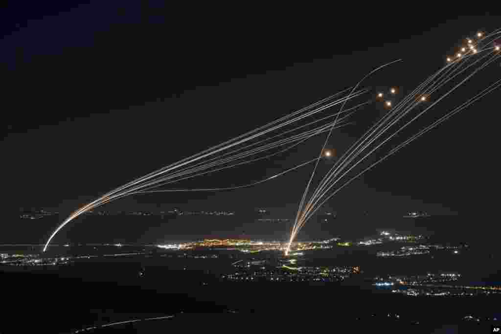 The Israeli Iron Dome air defense system fires to intercept an attack from Lebanon over the Galilee region as seen from the Israeli-annexed Golan Heights.