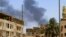 Smoke rises behind buildings in Khartoum, Sudan, on April 19, 2023, as fighting between the army and paramilitaries raged for a fifth day after a 24-hour truce collapsed.