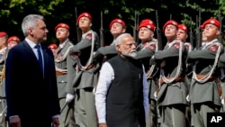 Indian Prime Minister Narendra Modi, right, is welcomed with military honors by Austria's Chancellor Karl Nehammer in Vienna, July 10, 2024.