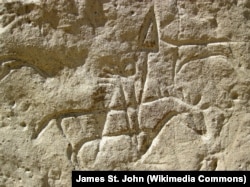 Ancestral Shoshone Indian-carved petroglyph on a sandstone cliff face of White Mountain, Wyoming, estimated to be from 200 to 1000 years old.