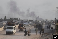 FILE - Palestinians flee from the southern Gaza city of Rafah during an Israeli ground and air offensive in the city, May 28, 2024.