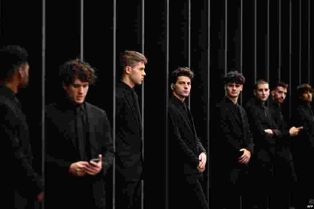 Security staff members stand outside before the Gucci fashion show during the Milan Fashion Week Womenswear Spring/Summer 2024 in Milan.