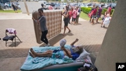 Thomas Leonard lies down at an evacuation center in Wailuku, Hawaii, after his Lahaina apartment burned down on Aug. 10, 2023. His daughter, Sherrie Esquivel of North Carolina, spent frantic days trying to find her father. Neighbors told her early Friday that he was safe.