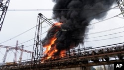 Flames and smoke rise from a blaze at an electricity facility after a Russian attack in Kharkiv, Ukraine, March 22, 2024. Attacks on energy facilities in the Kharkiv region caused blackouts and disrupted critical air-raid siren systems.