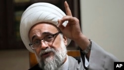 Shiite cleric Yasser Auda gestures as he speaks during an interview with The Associated Press, at his house in a southern suburb of Beirut, Lebanon, Aug. 18, 2023.