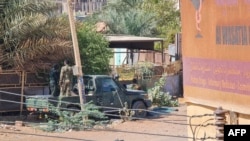 Members of security forces affiliated with the Sudanese Army man a position by their vehicle in the Jabra neighborhood of Khartoum, on May 1, 2023, as clashes continue in war-torn Sudan.