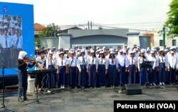 Koor pelajar Surabaya menyanyikan lagu-lagu karya pahlawan nasional WR Soepratman dalam perayaan Hari Musik Nasional yang digelar di kompleks makam WR Soepratman di Surabaya, Jawa Timur, 9 Maret 2023. (Foto: Petrus Riski/VOA)