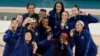 Members of the United States team pose for a picture with their gold medals at Bercy Arena at the 2024 Summer Olympics, in Paris, France, Aug. 11, 2024.