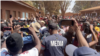 FILE - Journalists cover a political rally in August 2023 in Harare, Zimbabwe. Journalists say security officials ordered them to delete photos and video of Second Vice President Kembo Mohadi collapsing at a political rally in Gutu province on Oct. 21.
