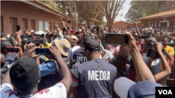 FILE - Journalists cover a political rally in August 2023 in Harare, Zimbabwe. Journalists say security officials ordered them to delete photos and video of Second Vice President Kembo Mohadi collapsing at a political rally in Gutu province on Oct. 21.